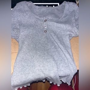 Grey ribbed top with buttons.